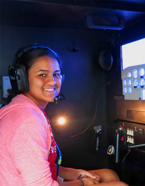 air camp student sitting in an aviation simulator