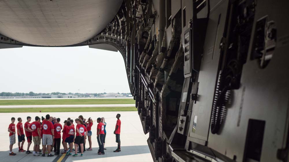 air camp students in storage area of a large plane