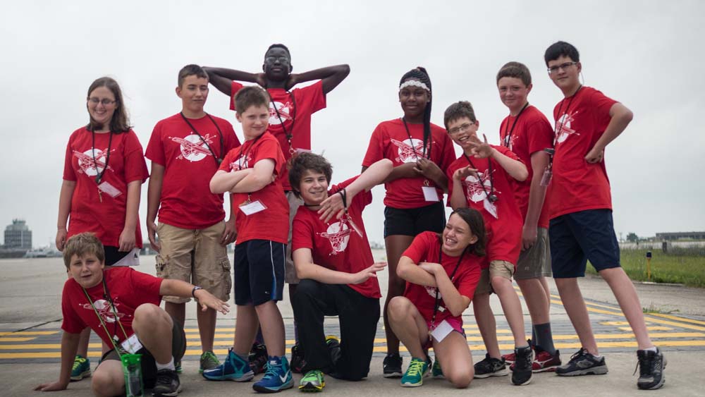 air camp students posing on tarmac