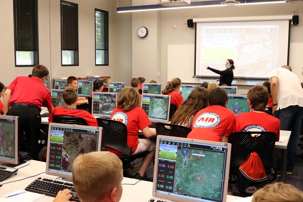 air camp students using an aviation simulator