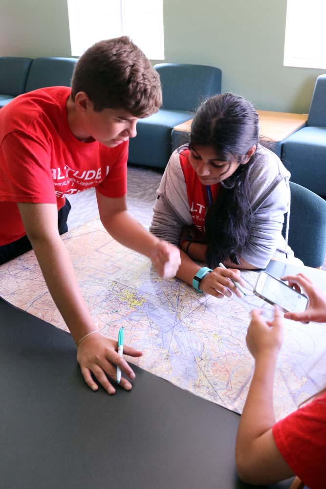 air camp students writing on a map