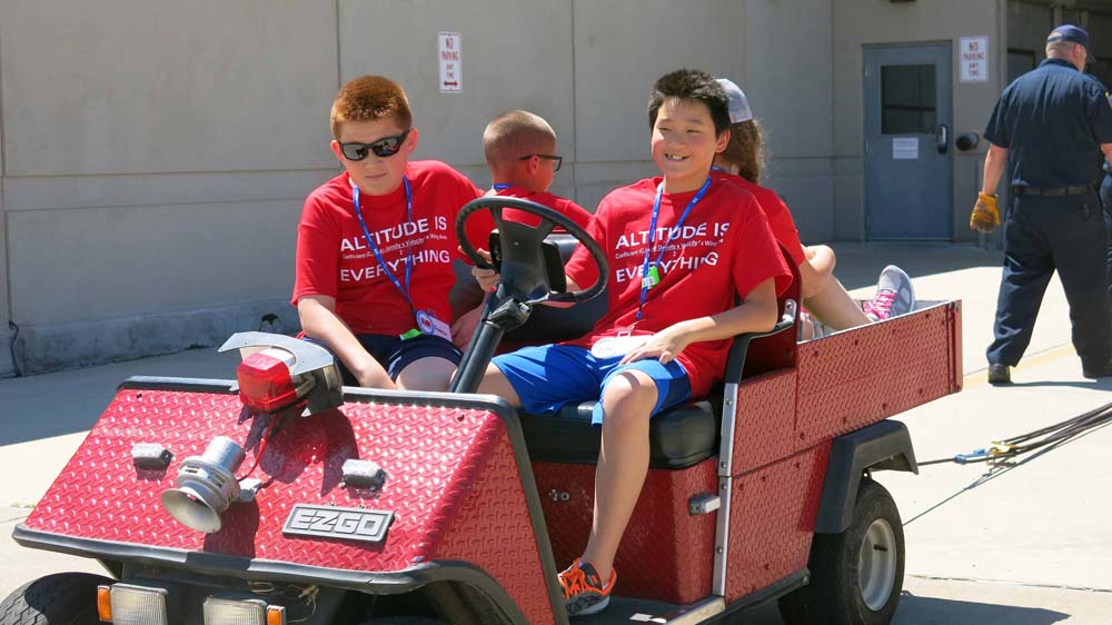 air camp students riding on a cart