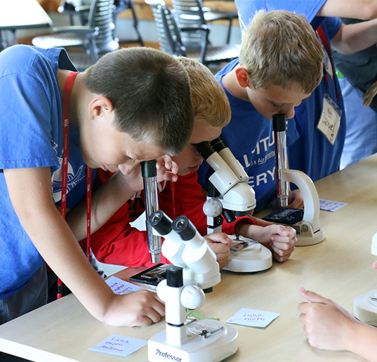 kids looking through microscopes
